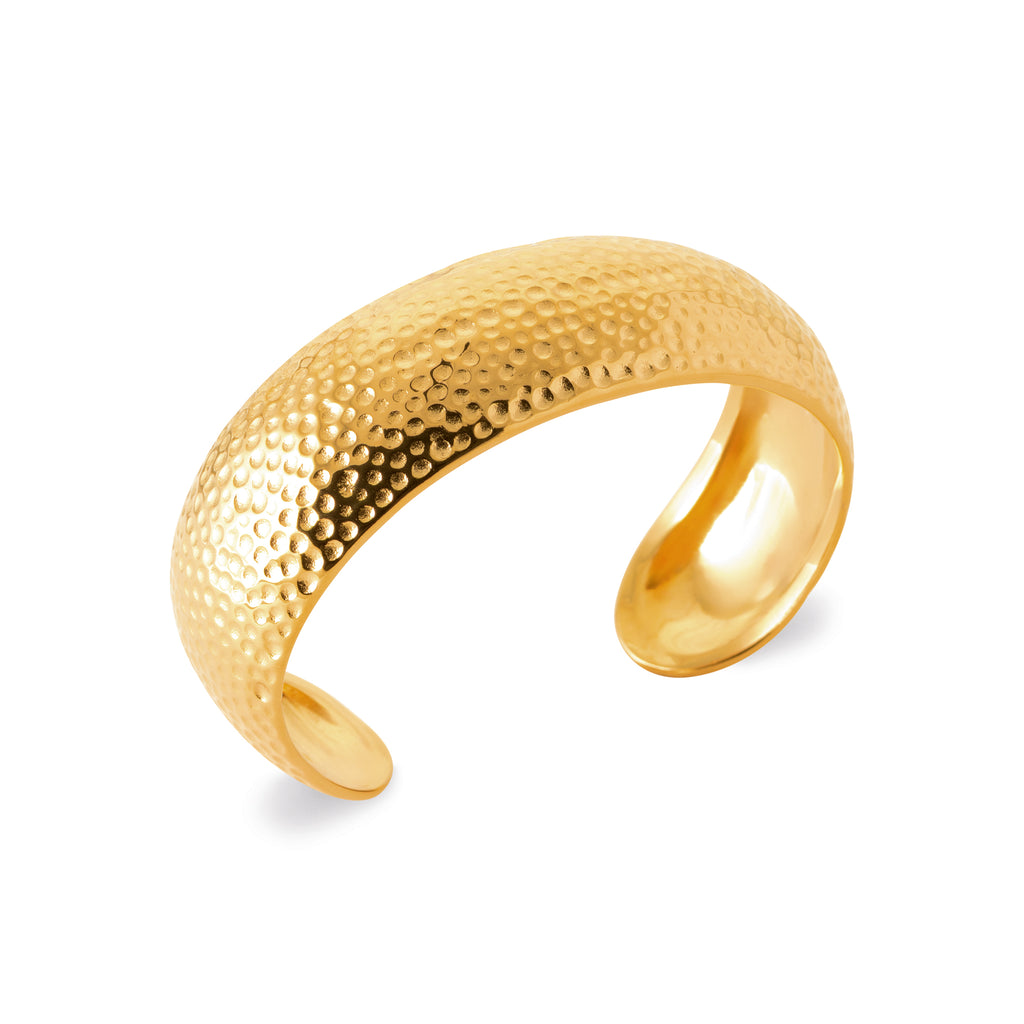 Gold-tone hammered cuff bracelet with a textured surface and bold sculptural design by HNKO