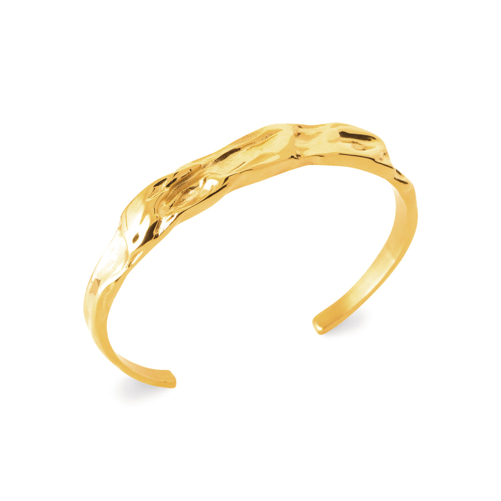 Golden textured bracelet on a white background