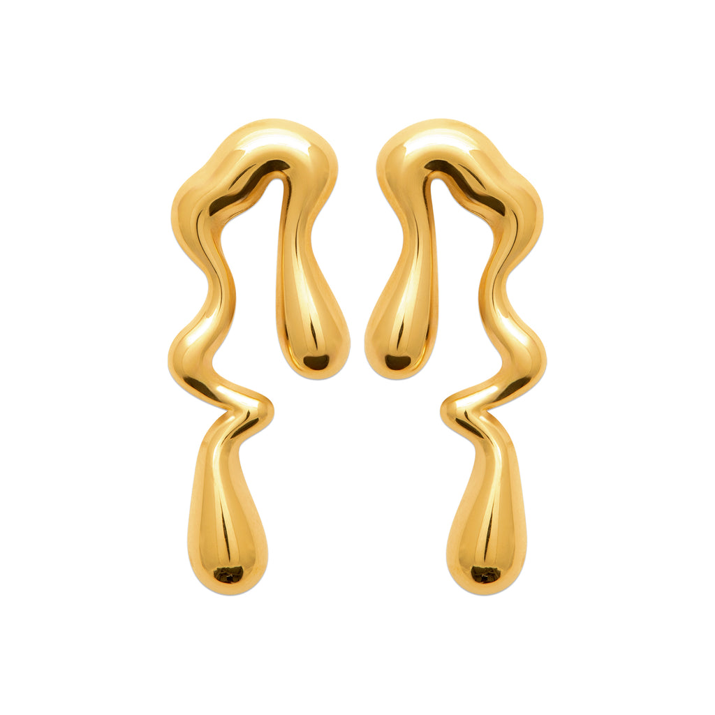 A pair of abstract, wavy gold earrings with a glossy, liquid-like metallic finish, displayed on a solid white background.