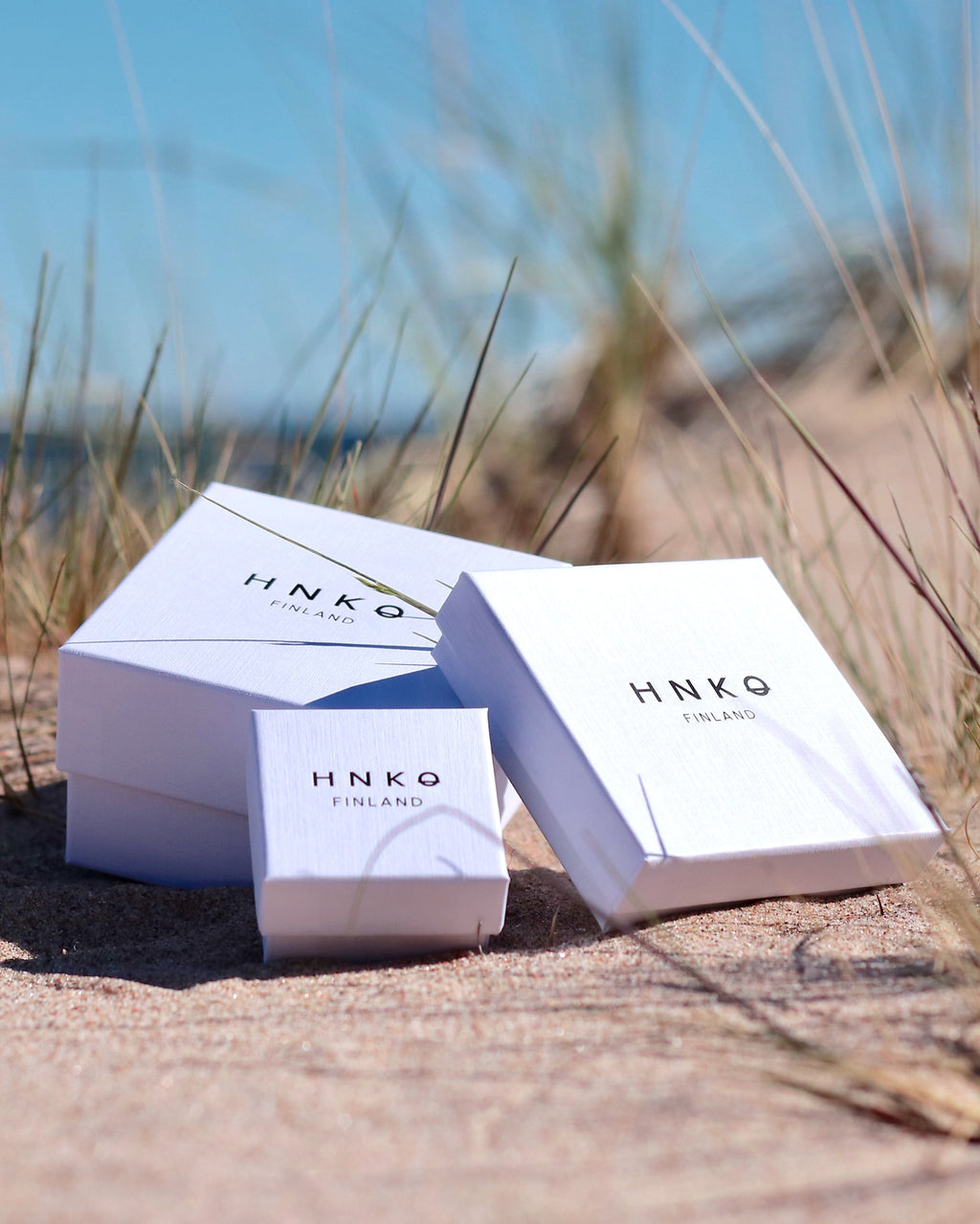 Jewelry gift boxes by HNKO photographed on a beach in Hanko, Finland
