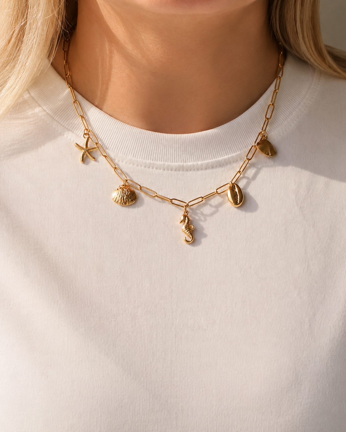 Model wearing HNKO sea life charm necklace in gold-tone stainless steel
